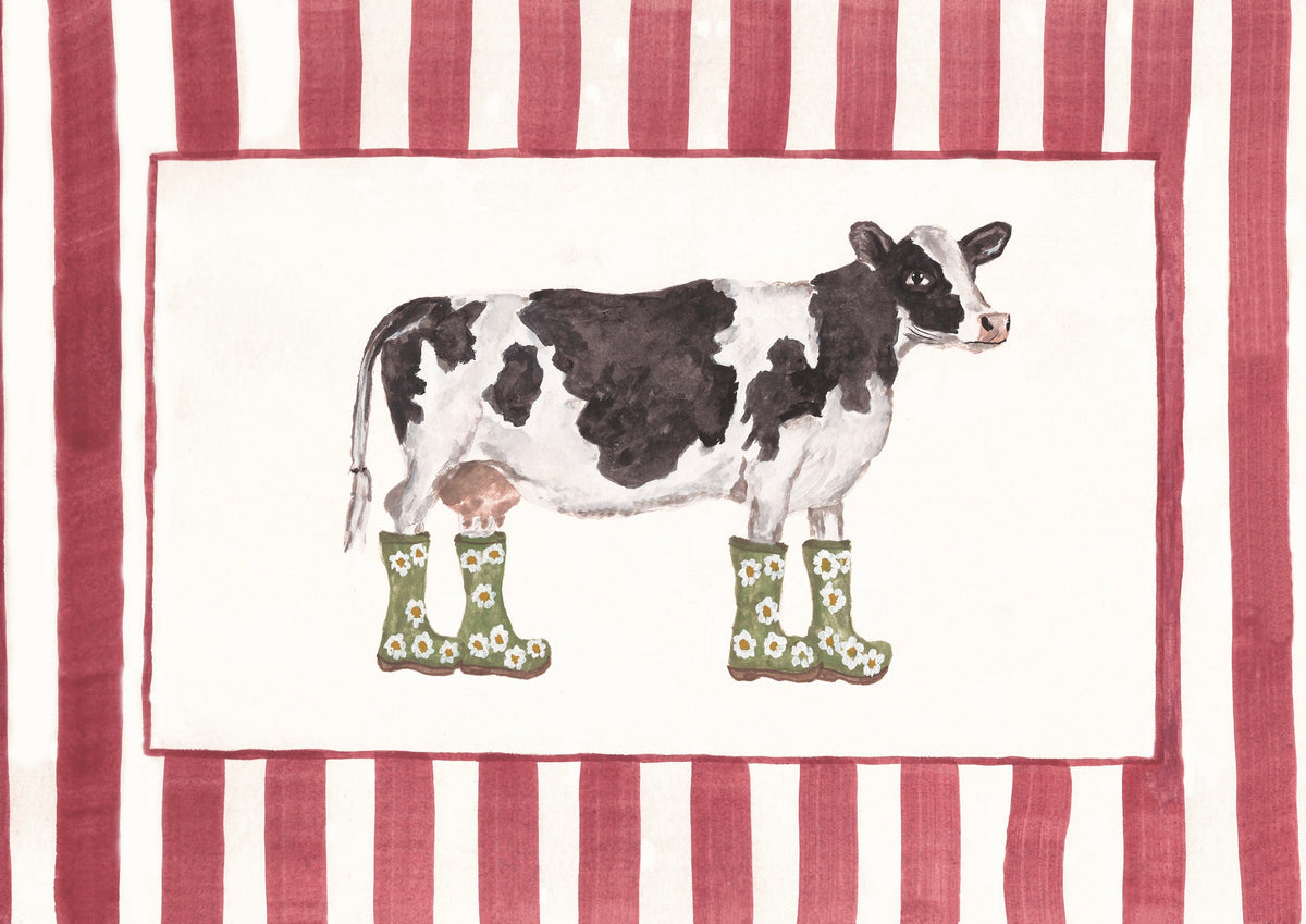 A print featuring a watercolor-style black-and-white cow wearing green rain boots with daisy patterns, centered on an off-white field with a dark pink border. The design is framed by pink-and-white vertical stripes.