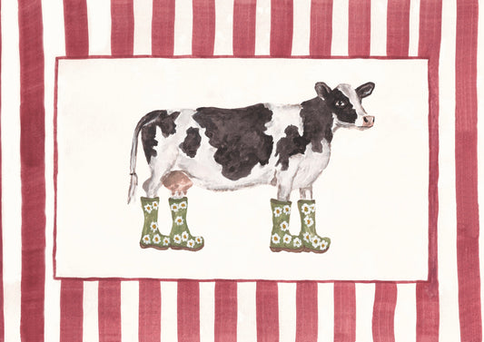 A print featuring a watercolor-style black-and-white cow wearing green rain boots with daisy patterns, centered on an off-white field with a dark pink border. The design is framed by pink-and-white vertical stripes.
